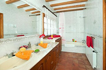 A bathroom with two sinks and a bathtub