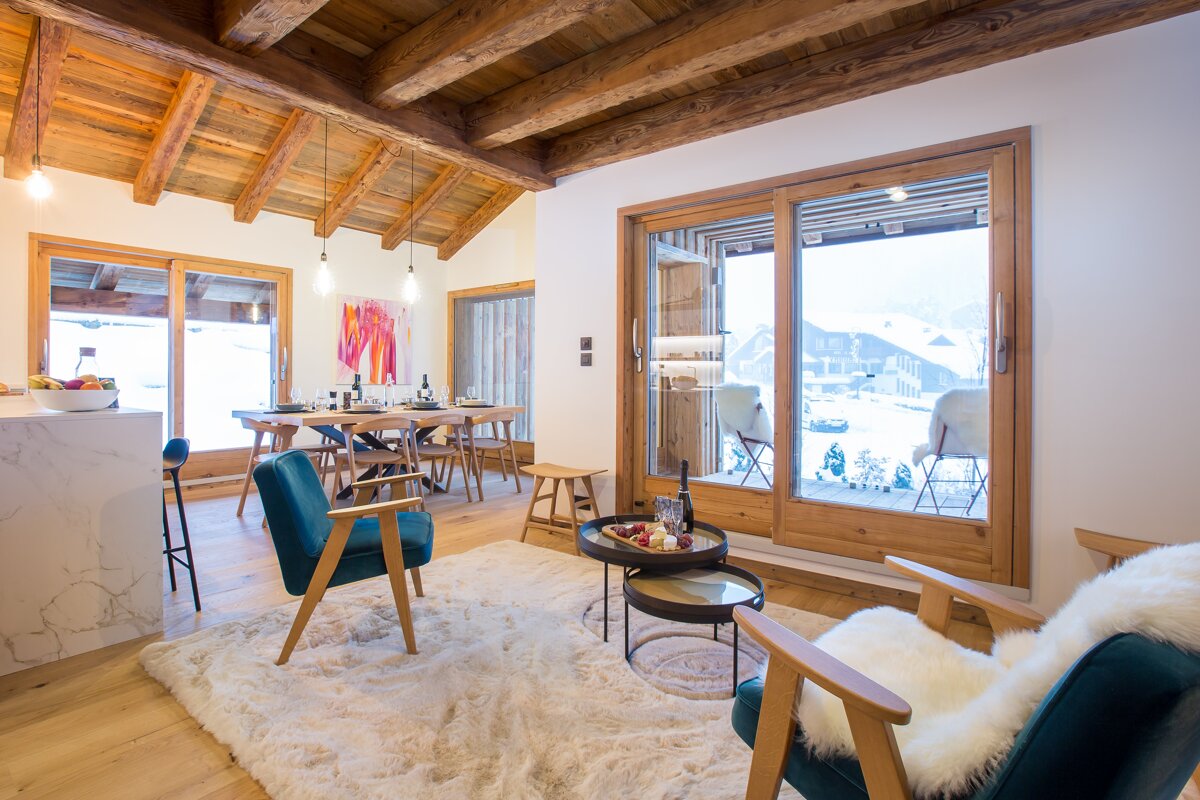 A living room with a table and chairs and a sliding glass door