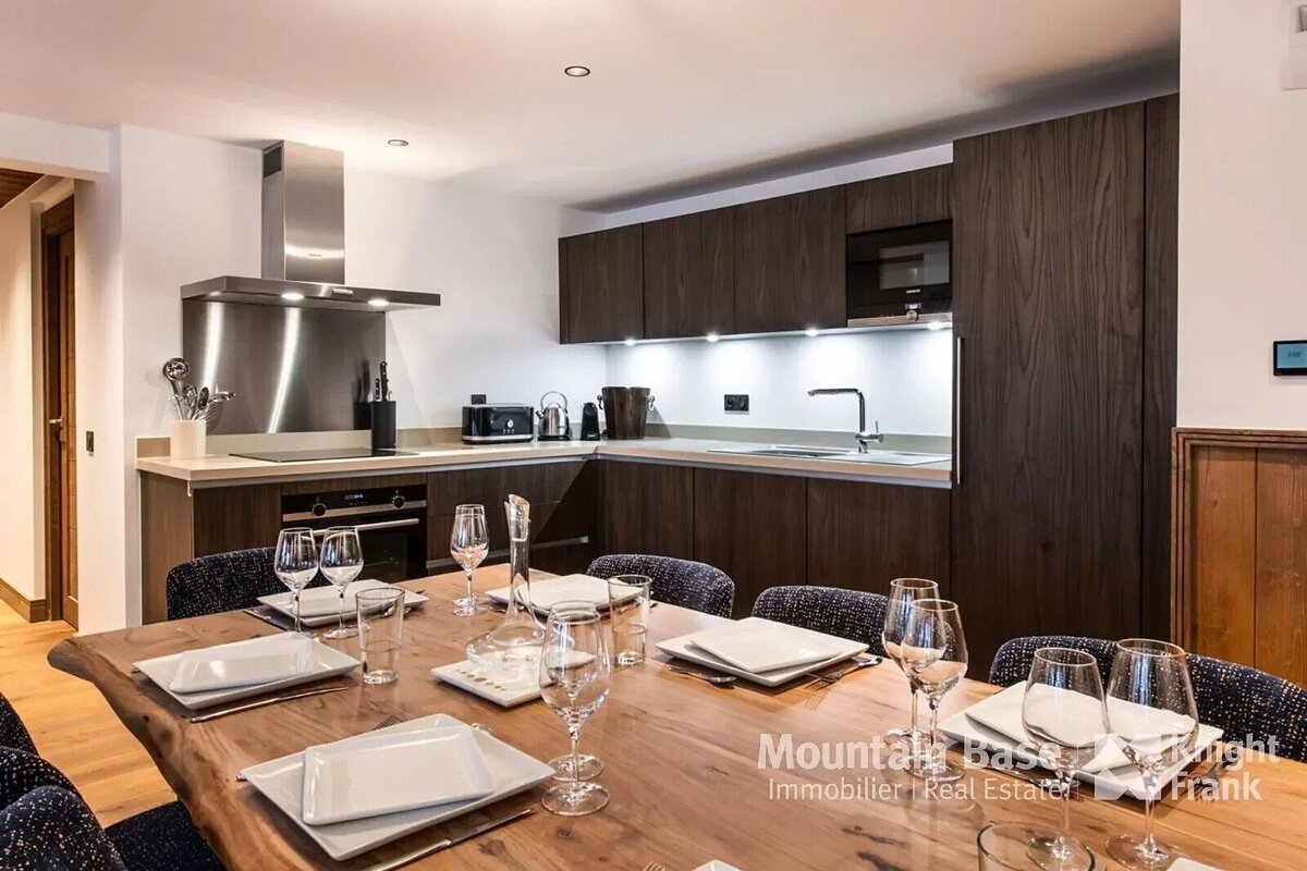 A kitchen with a table set for dinner and a sign that says mountain base high frank