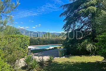 A swimming pool is surrounded by trees and bushes and the word home is on the bottom