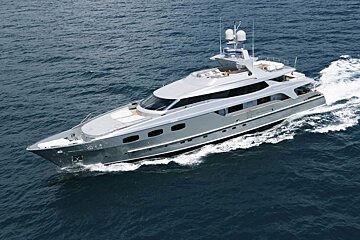 A large gray yacht is floating in the ocean