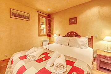 A bedroom with a bed and a sign on the wall that says
