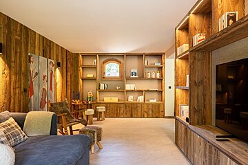 A living room with wooden shelves and a couch