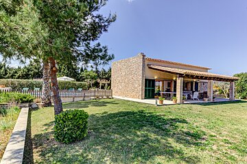 A house with a large lawn in front of it