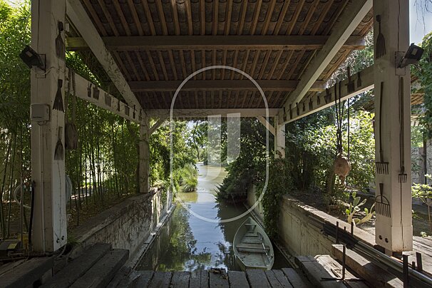 A wooden bridge over a river with the letter u in the middle