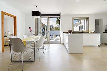 A kitchen and dining area with a table and chairs