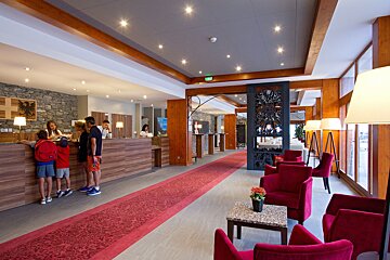 People standing at a counter in a hotel lobby
