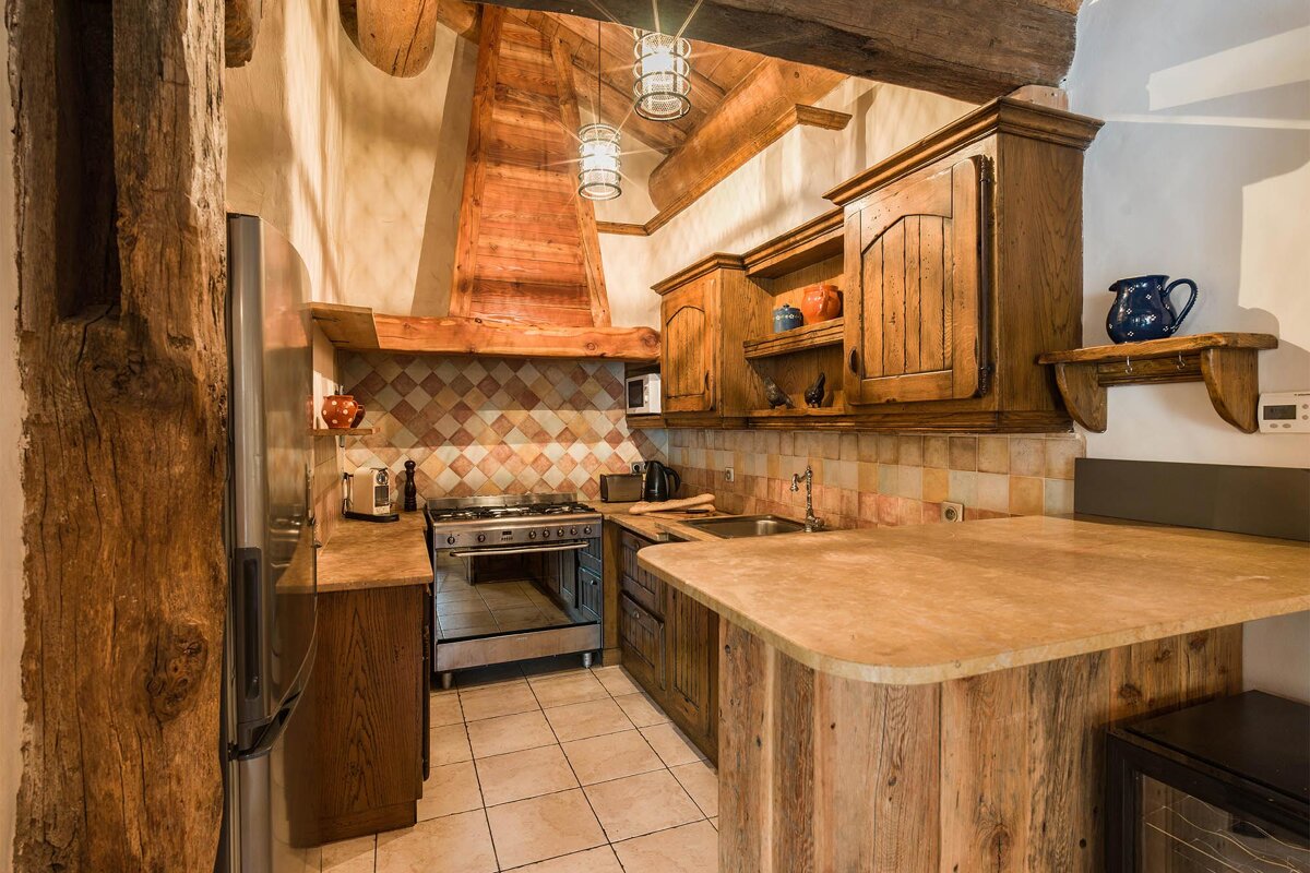 A kitchen with wooden cabinets and stainless steel appliances