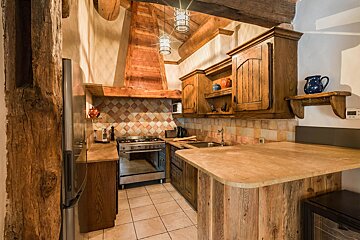 A kitchen with wooden cabinets and stainless steel appliances