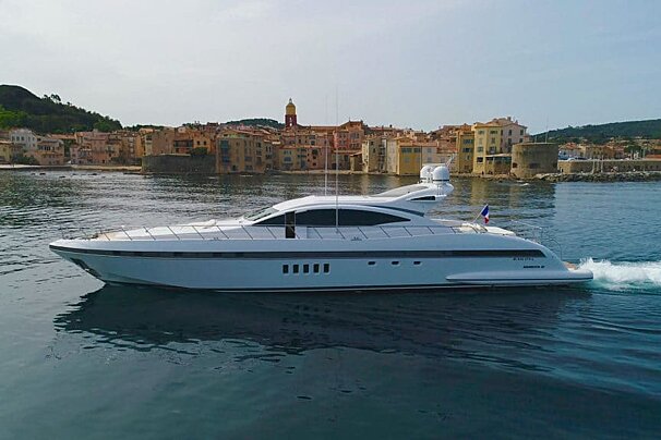 A large white yacht is floating on a body of water