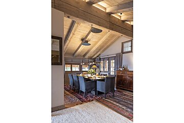 A dining room with a long table and chairs
