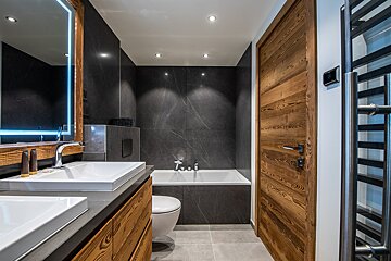 A bathroom with a sink toilet and bathtub