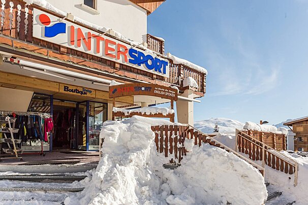 A snowy entrance to a store called intersport