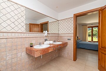 A bathroom with two sinks and a mirror