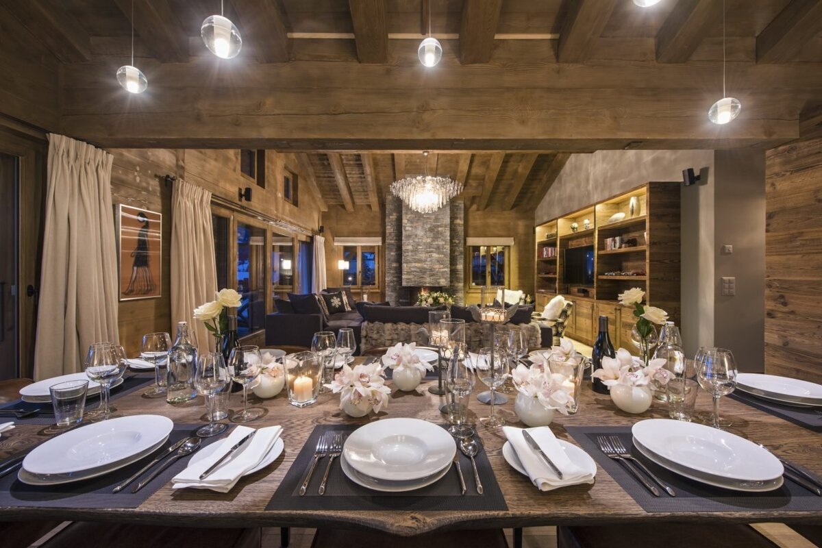 A dining room table with plates and utensils on it