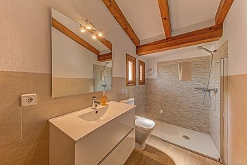 A bathroom with a toilet a sink and a shower