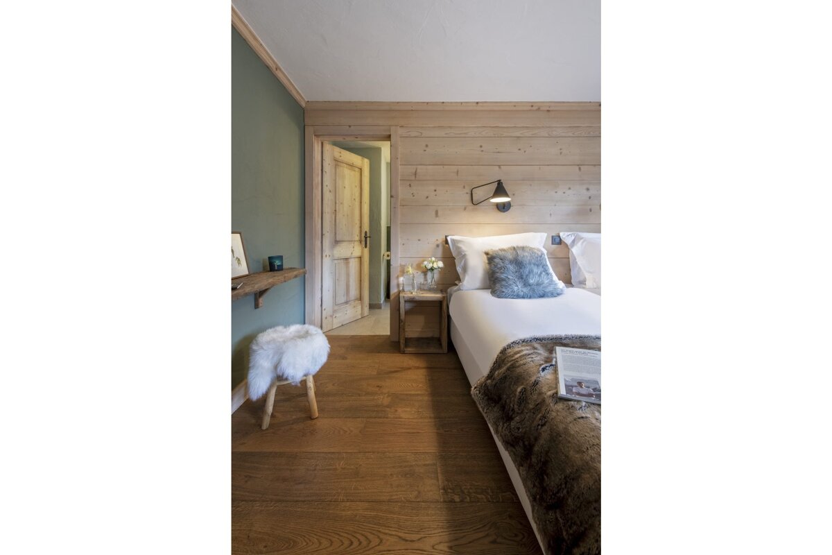 A bedroom with a bed and a book on the bed