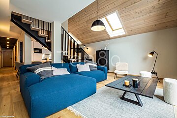 A living room with a blue couch and a coffee table