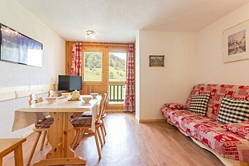 A living room with a couch and a table