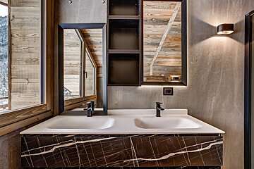 A bathroom with two sinks and a mirror