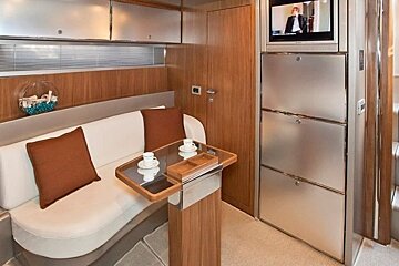 A room with a couch a table and a television