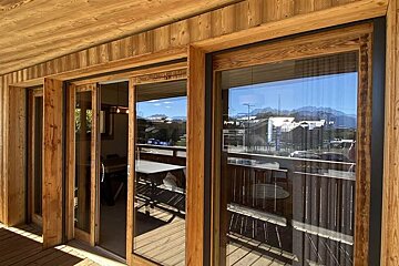 A wooden building with a sliding glass door