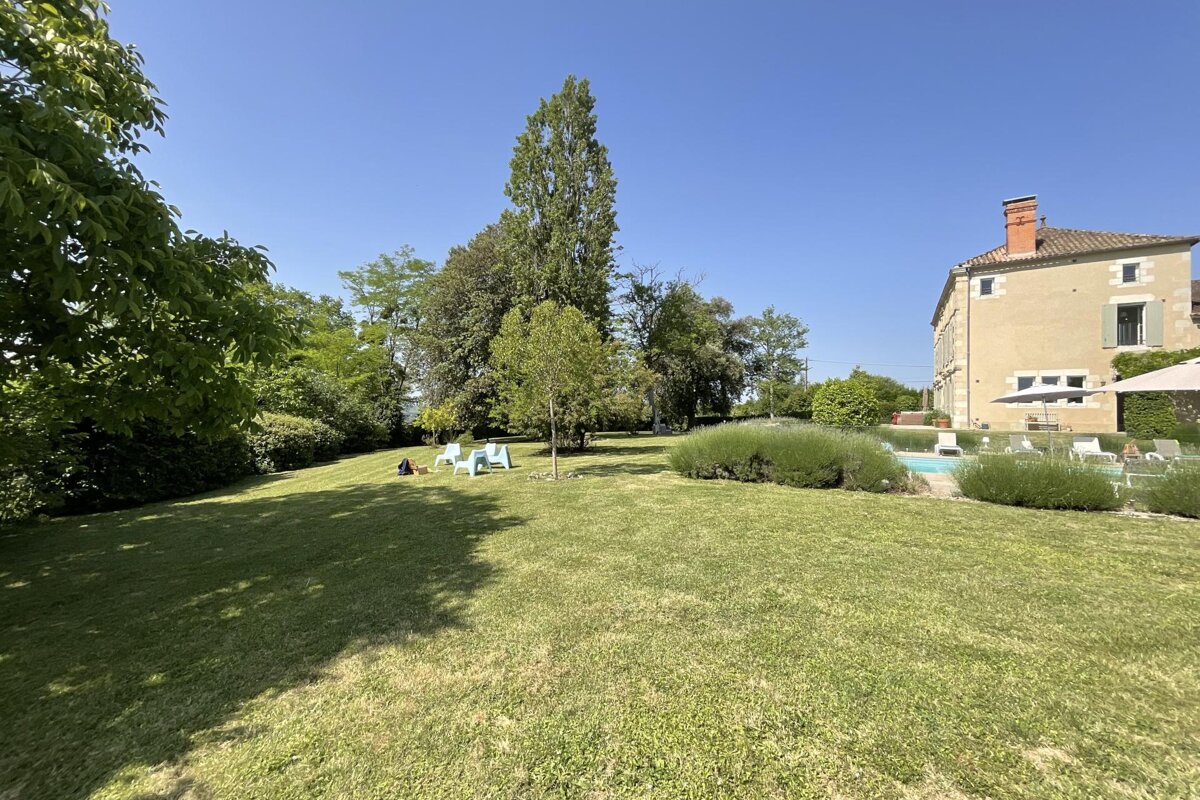 A large house with a large lawn in front of it