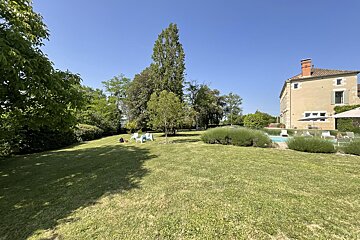 A large house with a large lawn in front of it