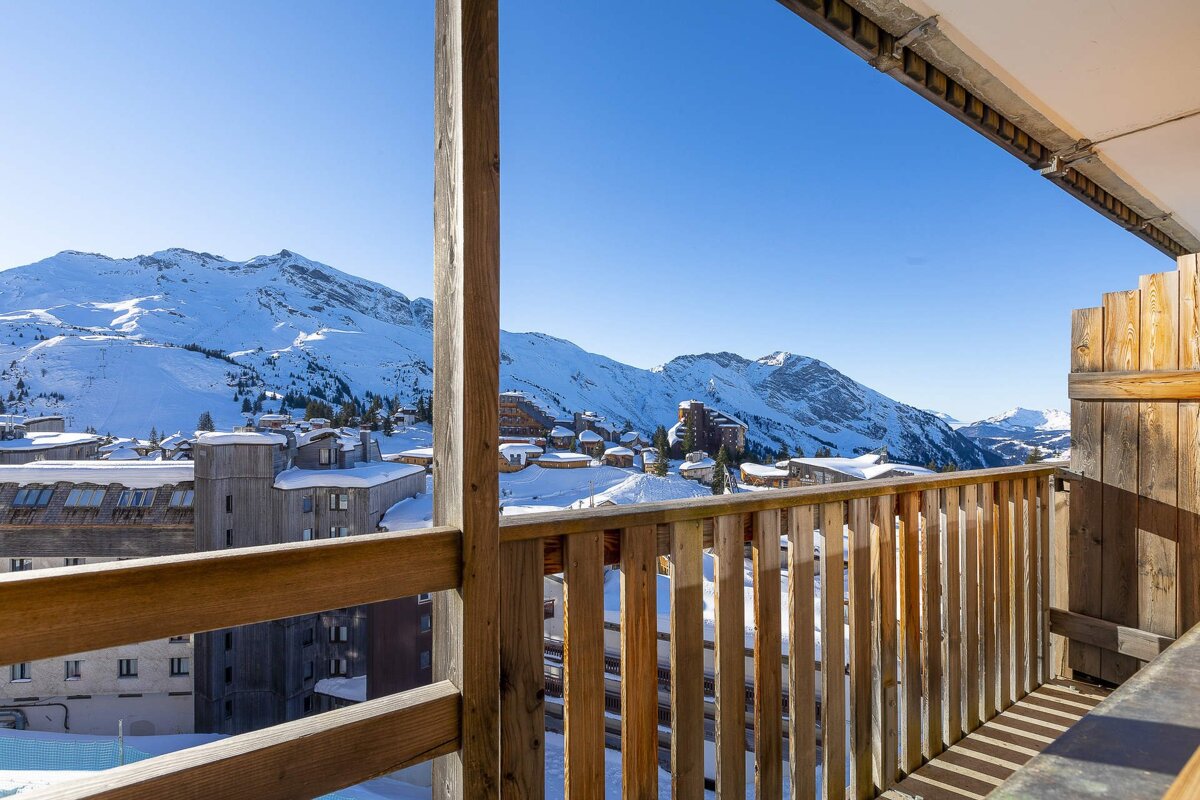 A balcony with a view of snow covered mountains