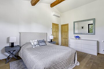 A bedroom with a bed and two pillows that say home