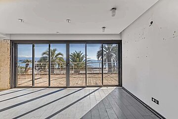 An empty room with sliding glass doors leading to a balcony