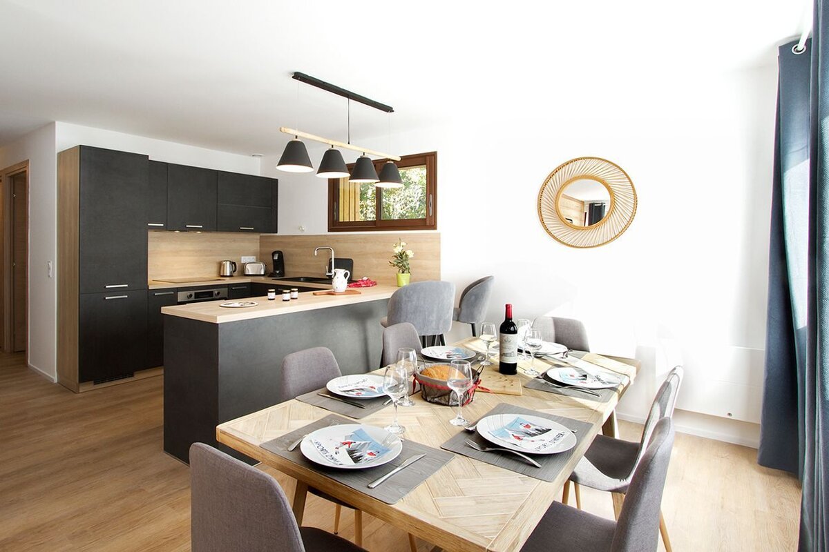 A bottle of wine sits on a table in a kitchen