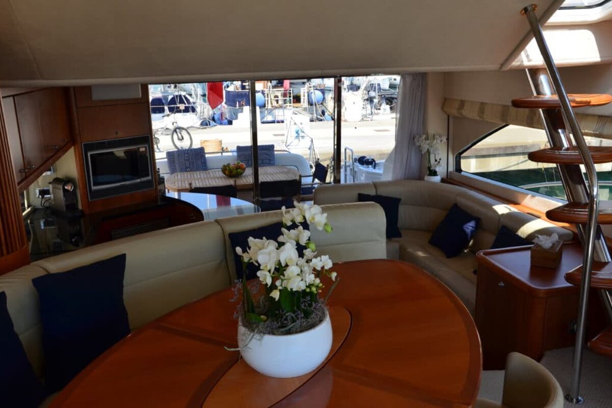 A living room with a table and a vase of flowers