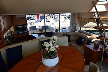A living room with a table and a vase of flowers