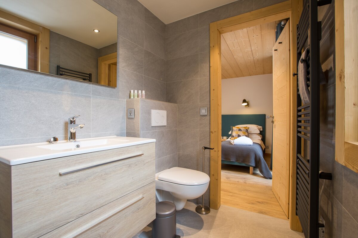 A bathroom with a toilet a sink and a mirror