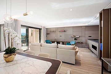 A living room with a white couch and blue chairs