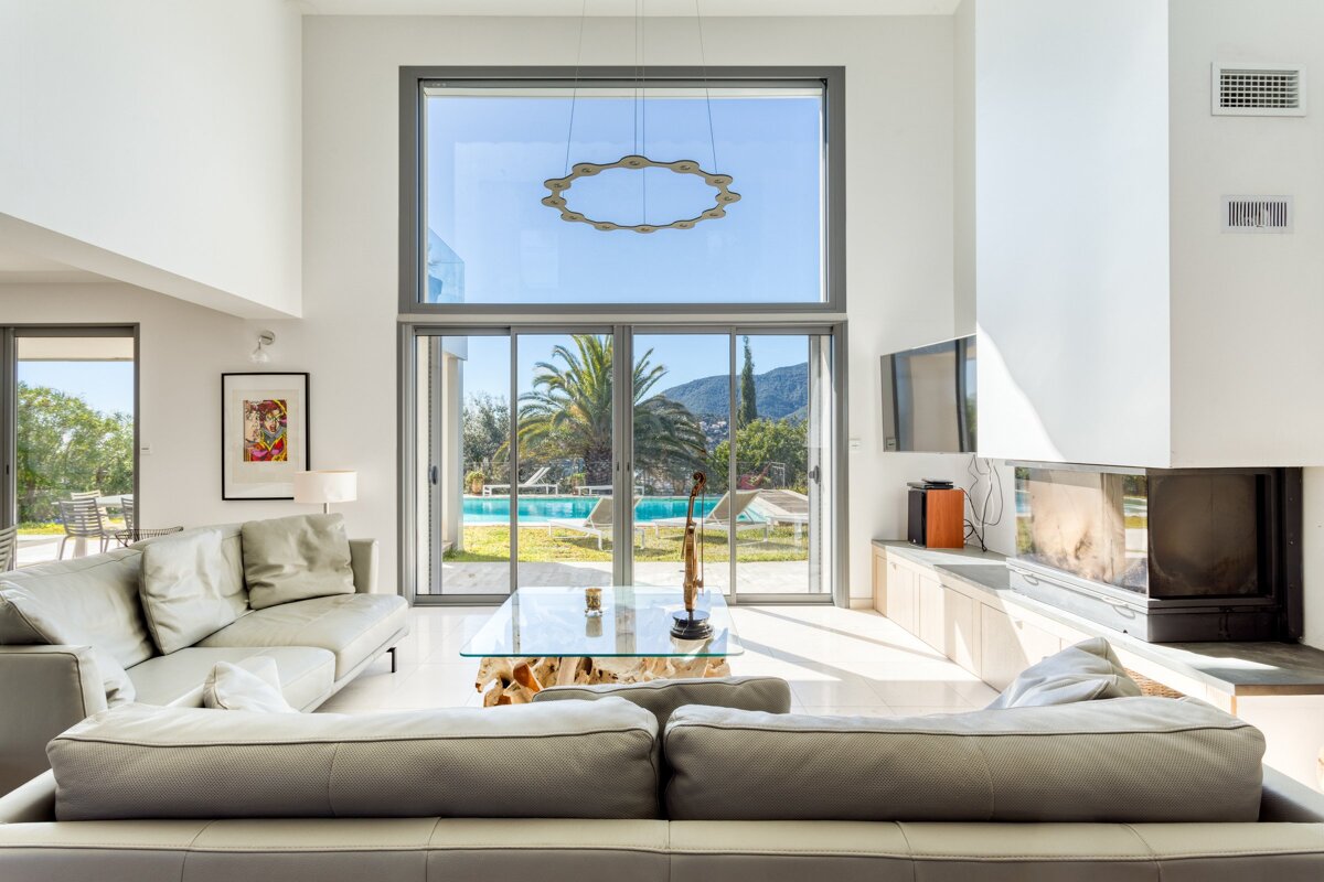 A living room with a fireplace and a large window