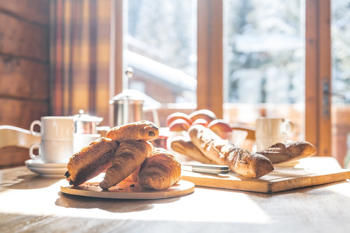 A bunch of croissants on a cutting board on a table
