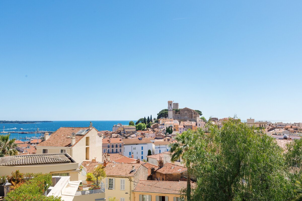 A view of a city with the ocean in the background
