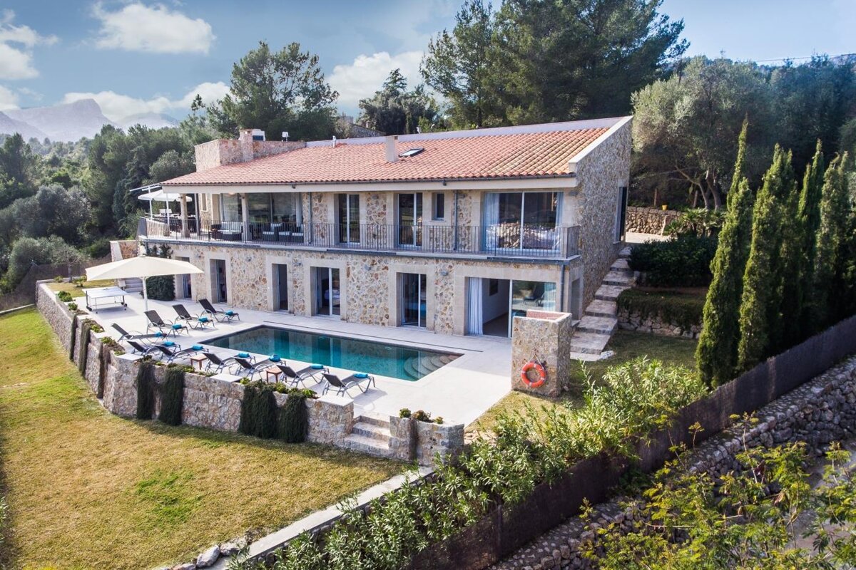 An aerial view of a large house with a swimming pool