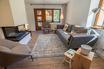 A living room with a couch a chair and a fireplace