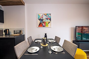 A dining room table with plates and glasses on it