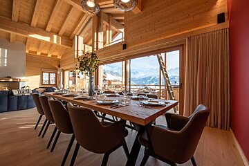 A dining room table with plates and glasses on it