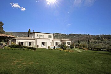A large house with a large lawn in front of it