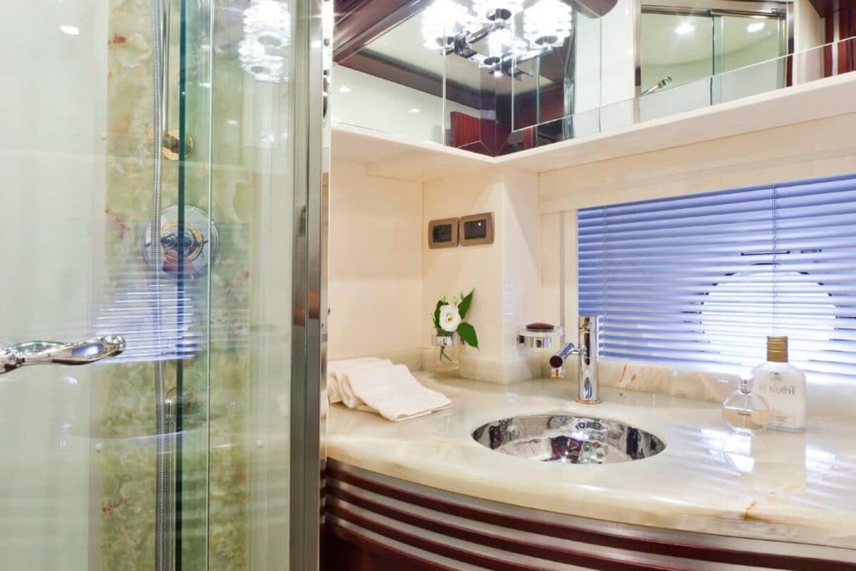 A bathroom with a sink and a bottle of eau de toilette