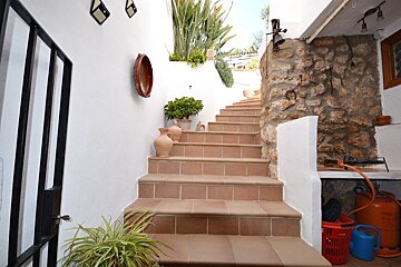 A set of stairs leading up to a stone wall