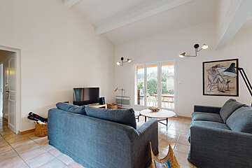 A living room with a couch and a television