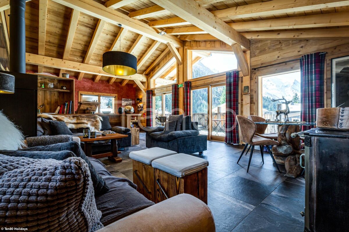 A living room with a couch and chairs and a table