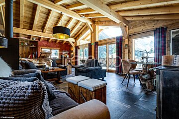 A living room with a couch and chairs and a table