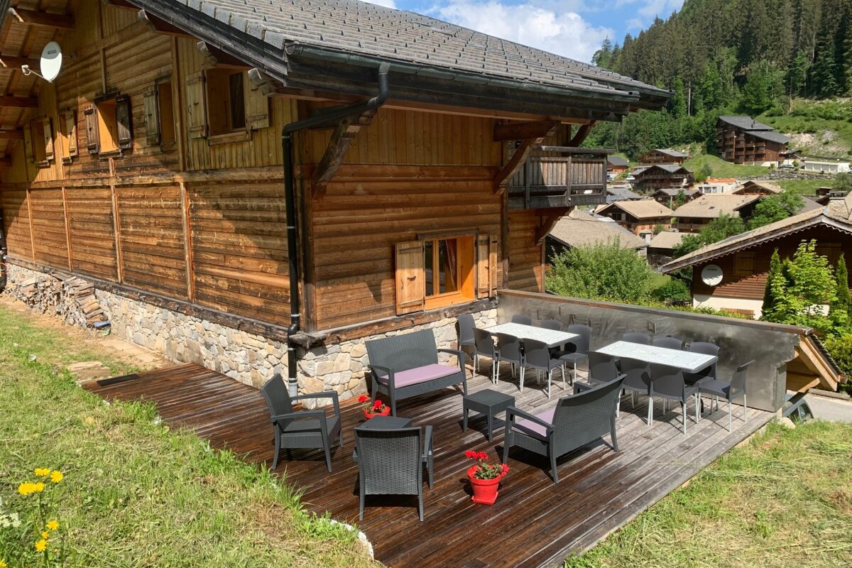 A wooden house with a satellite dish on top of it